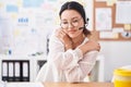 Hispanic young woman working at the office wearing headset and glasses hugging oneself happy and positive, smiling confident Royalty Free Stock Photo