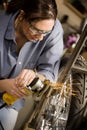 Hispaninc womman using grinder on motorcycle