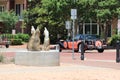 Statue of Cayotes appear to howel as classic car passes. Royalty Free Stock Photo