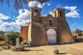 Historic adobe San Francisco de Asis Mission Church in Taos New Mexico in dramatic late afternoon light under intense blue sky wit Royalty Free Stock Photo