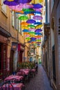 Historic alley and restaurant in BÃÂ©ziers in France in the shade of umbrellas