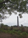 Historic ancient chimney building in the middle of rice fields with clear sky view