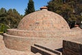 Historic ancient round building surrounded by a forest