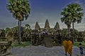 The historic Angkor Temple with tourists and priests.