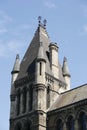 Historic architecture of a building tower with spires on each corner and a chimney