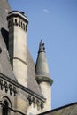 Historic architecture of a building tower with spires on each corner and a chimney