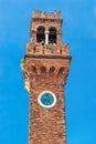 Historic architecture San Stefano Church Bell Tower with clock in Murano island, famous by glass making, Italy, Venice, against Royalty Free Stock Photo