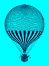 Historic balloon with several passengers standing in the basket in front of a blue background