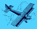 Historic biplane with foldable wings in top view flying over large cumulus clouds on a blue background Royalty Free Stock Photo