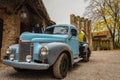 Historic blue-colored pickup parked in the streets