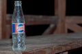 Poland Czarna Glina(Black Clay ) November 14, 2023 at 16:11. An old Pepsi-Cola bottle standing on a wooden table.