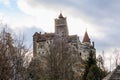 Historic bran castle in winter landscape with dramatic sky and leafless trees Royalty Free Stock Photo