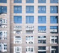 Historic building mirrored in glass facade of modern office building Royalty Free Stock Photo