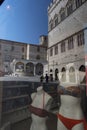 Historic buildings in Perugia reflected in a shop window