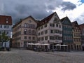 Historic buildings at Rathausplatz square in the old center of Esslingen with shops and cafe with outdoor seating.