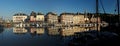 Historic Buildings Reflecting In The Water Of The Old Harbour In Honfleur Normandy France On A Beautiful Sunny Summer Day