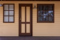 Historic cabin entrance door and two windows.