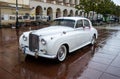 Historic car waiting for just married couple in front of a luxury hotel in the center of Warsaw