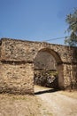 Casa Hacienda de Yaca from the abandoned and dilapidated sugar industry arc and door dirth road 20th century adobe Royalty Free Stock Photo