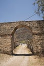 Casa Hacienda de Yaca from the abandoned and dilapidated sugar industry arc and door dirth road 20th century adobe Royalty Free Stock Photo