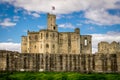 A historic castle with a flag of northumberland