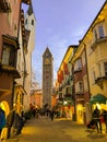 Historic center of Vipiteno Sterzing with christmas decorations and lights. Tourists walking in the main street of city