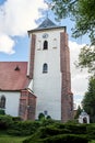 Historic church with a bell tower with a clock in the city of Oborniki Royalty Free Stock Photo