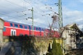 Historic churchyard wall in front of a modern train