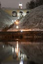 Historic city center at night in the light of night lighting. Night photo of the city. Reflection of houses in the river. A long