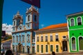 Historic city center of Pelourinho features brightly lit skyline of colonial architecture on a broad cobblestone hill in Salvador Royalty Free Stock Photo