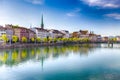 Historic city center of Zurich with famous Fraumunster Church and swans on river Limmat on a sunny day, Switzerland