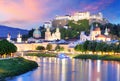 Historic city of Salzburg with Hohensalzburg Fortress at dusk, S
