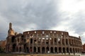 Historic Colosseum building under a cloudy sky in Rome, Italy