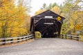 Historic covered bridge in a forested landscape on a cloudy autumn day Royalty Free Stock Photo