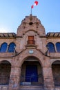 Historic Cusco building with Peruvian flag. Royalty Free Stock Photo