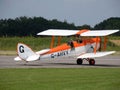 Historic biplane aircraft taxying on runway Royalty Free Stock Photo