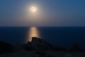 The full moon at night over the Mediterranean. In the foreground is a fortress. Royalty Free Stock Photo