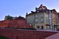 The historic defensive walls of the Warsaw Barbican and burgher houses in the Old Town in the light of the rising sun