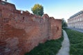 The historic defensive walls of the Warsaw Barbican and burgher houses in the Old Town in the light of the rising sun