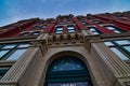 Historic detailed brick facade of an old building in downtown Wichita kansas with architectural details above the arched entry