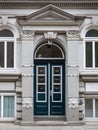 Historic double arched door with architrave.