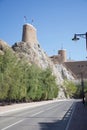 Historic fortress within the mountains near Old Town, Oman in the sunshine.