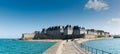 Historic French town of Saint-Malo in Normandy seen from the harbor wall jetty