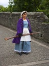 Historic girl in a costume with a musket on the walls of Londonderry