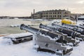 Historic guns on the pier at the Flight Harbor Museum in Tallinn in winter. Estonia Royalty Free Stock Photo