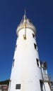Historic harbour lighthouse in scarborough yorkshire against a blue summer sky Royalty Free Stock Photo