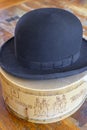 A historic hatbox from Berlin in the 19th century with a bowler on an old wooden table