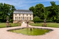Historic high school Lyceum building and gardens with fountain and statues in Echternach