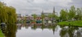 Historic homes and church at the Leiden city centrum, The city is intersected by numerous small canals with tree-bordered quays Royalty Free Stock Photo