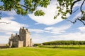 Historic hotel of Ackergill Tower at Sinclair Bay in the Scottish Highlands. Beautiful green lawn Royalty Free Stock Photo